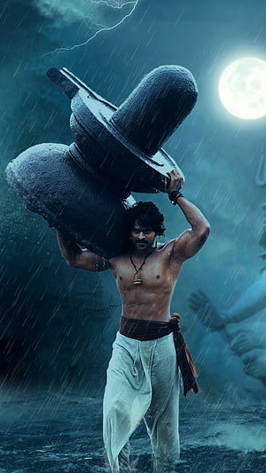 Paawan Singh lifting massive stone weight in heavy rain and thunderstorm HD phone wallpaper