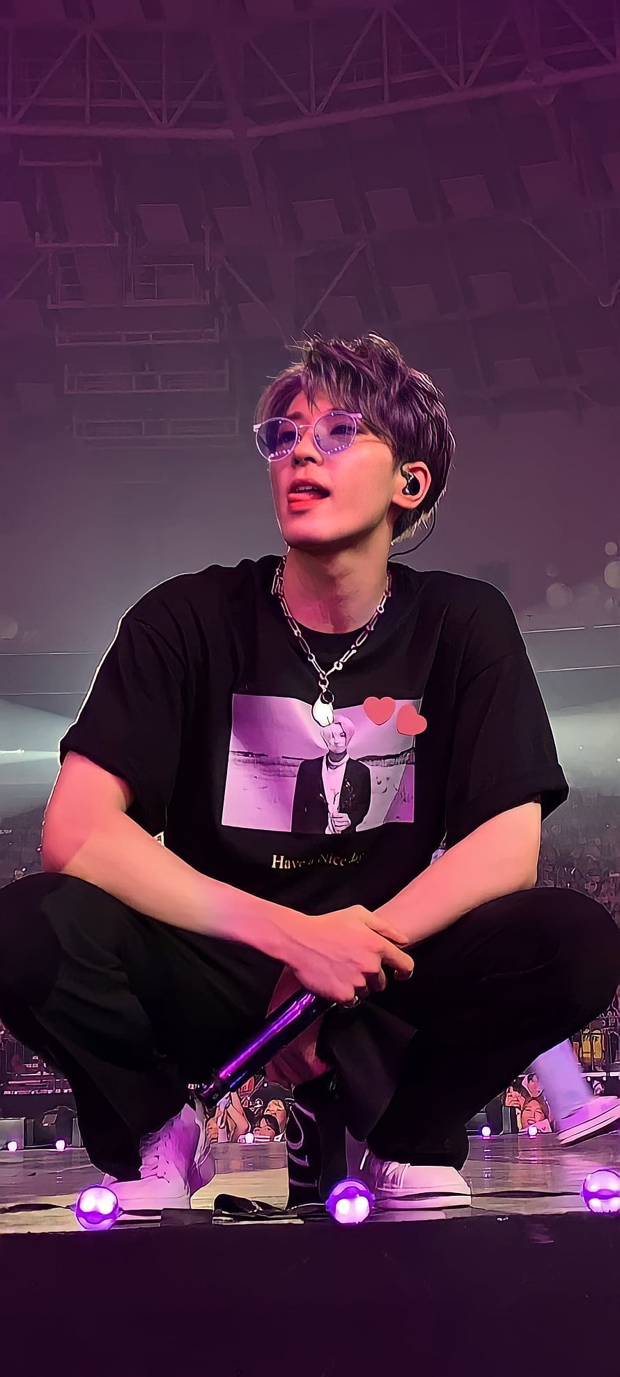 Wonwoo from Seventeen performing on stage in a black graphic tee and purple sunglasses HD phone wallpaper