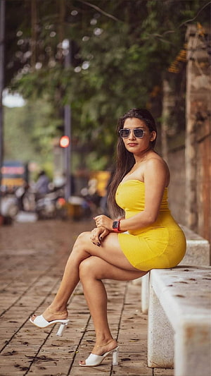 Reshmi Nair in a Vibrant Yellow Dress and White Heels on an Urban Street HD phone wallpaper
