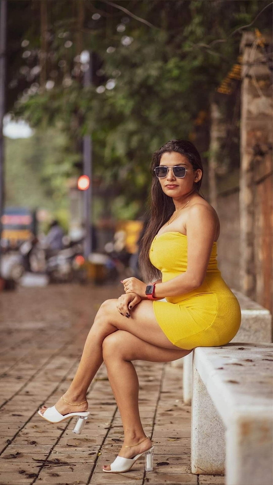 Reshmi Nair in a Vibrant Yellow Dress and White Heels on an Urban Street HD phone wallpaper