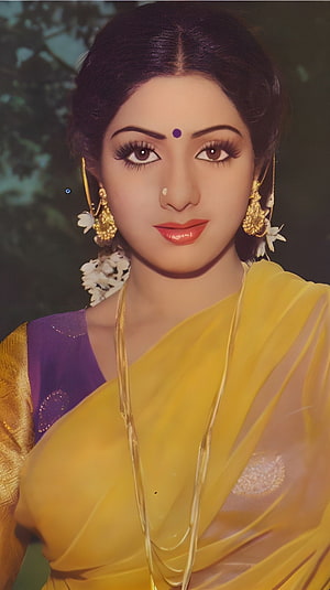 Portrait of a woman in a yellow saree with traditional gold jewelry and flowers, Sridevi, bollywood actress, saree beauty HD phone wallpaper