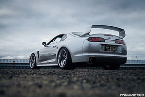 Silver Toyota Supra MK4 with Large Rear Wing on Overcast Road HD wallpaper