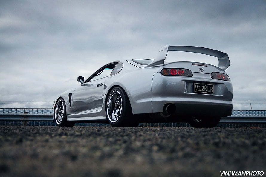 Silver Toyota Supra MK4 with Large Rear Wing on Overcast Road HD wallpaper
