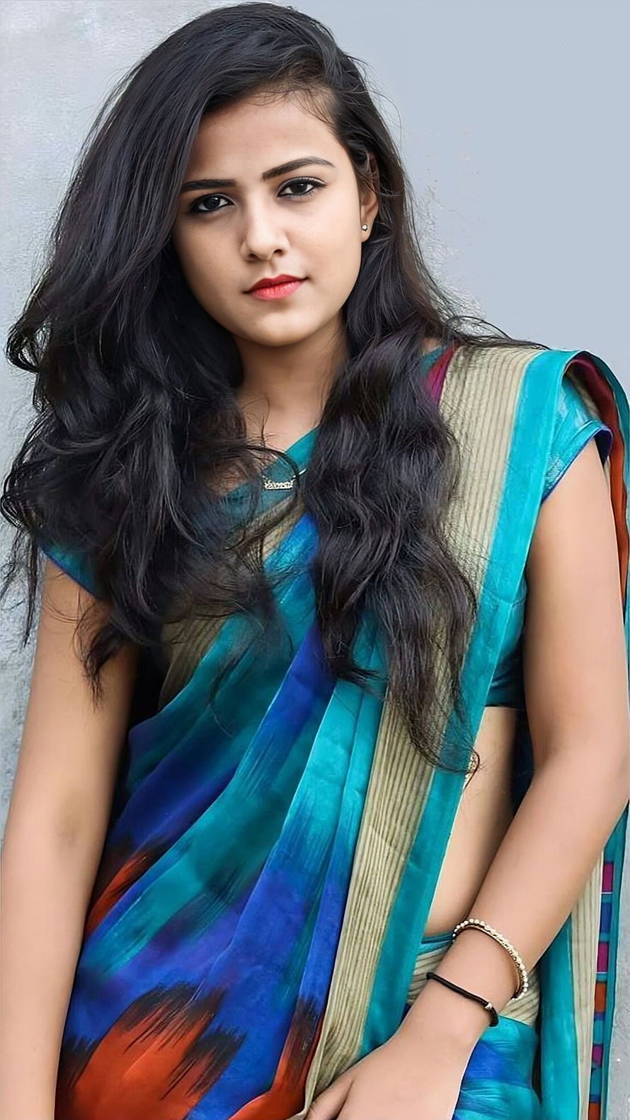Vaishnavi Chaitanya in a vibrant teal and blue patterned saree with long wavy hair HD phone wallpaper