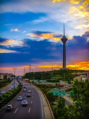 Tehran Milad Tower at Sunset with Highway Traffic and Dramatic Clouds HD phone wallpaper