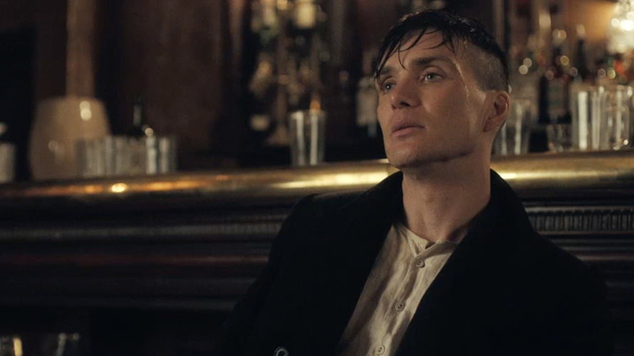 Cillian Murphy as Thomas Shelby in Peaky Blinders sitting at a dimly lit bar with a serious expression HD wallpaper