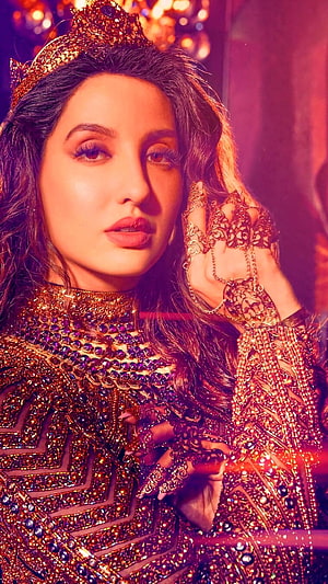 Nora Fatehi in ornate gold crown and jeweled ethnic attire with intricate hand jewelry HD phone wallpaper