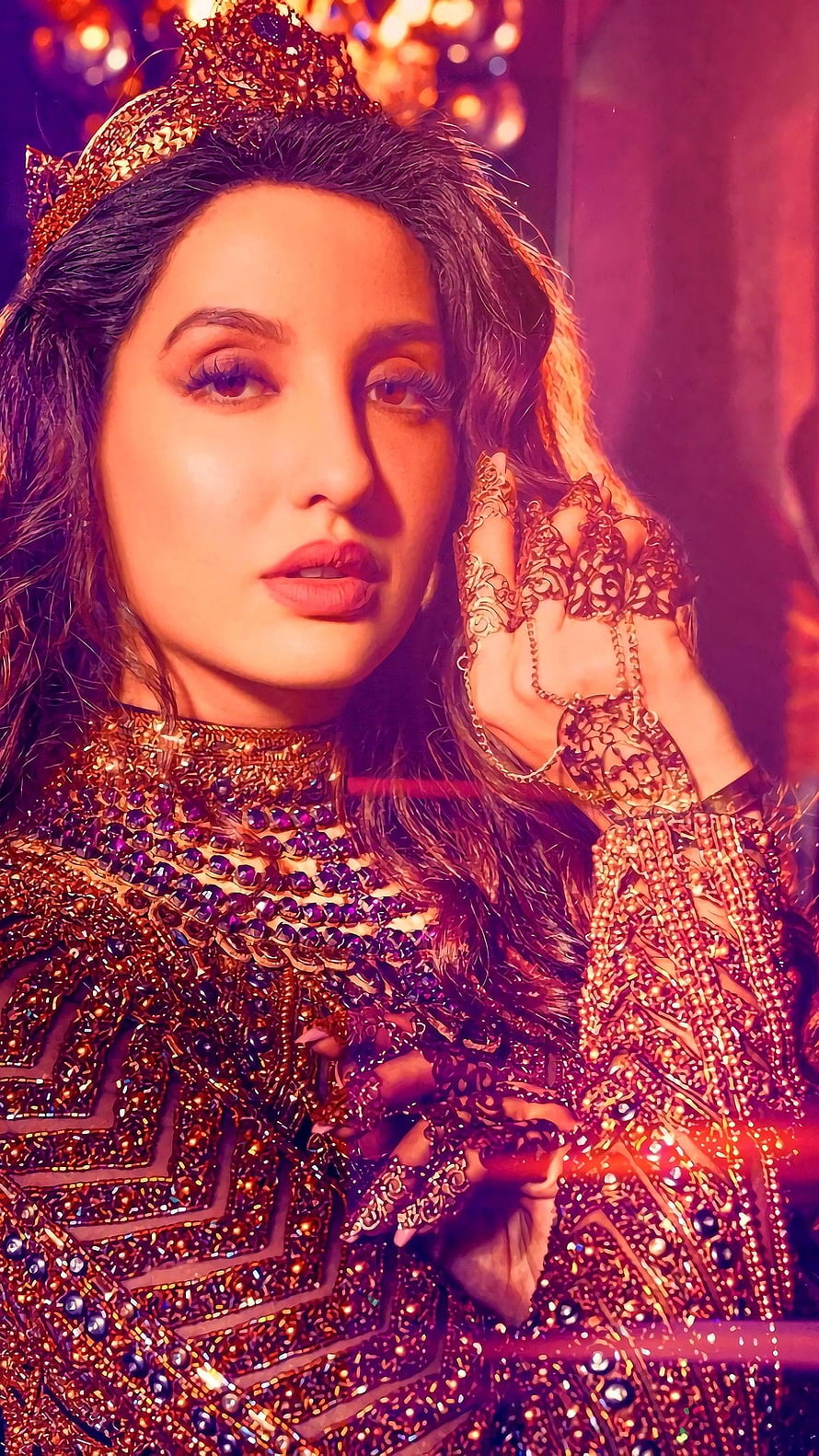Nora Fatehi in ornate gold crown and jeweled ethnic attire with intricate hand jewelry HD phone wallpaper