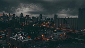Moody City Skyline at Dusk with Highway Traffic and Industrial Buildings HD wallpaper