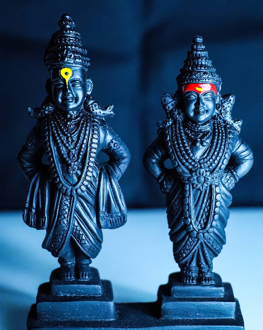 Black Resin Hindu Deity Statues with Traditional Jewelry and Tilak Markings HD phone wallpaper