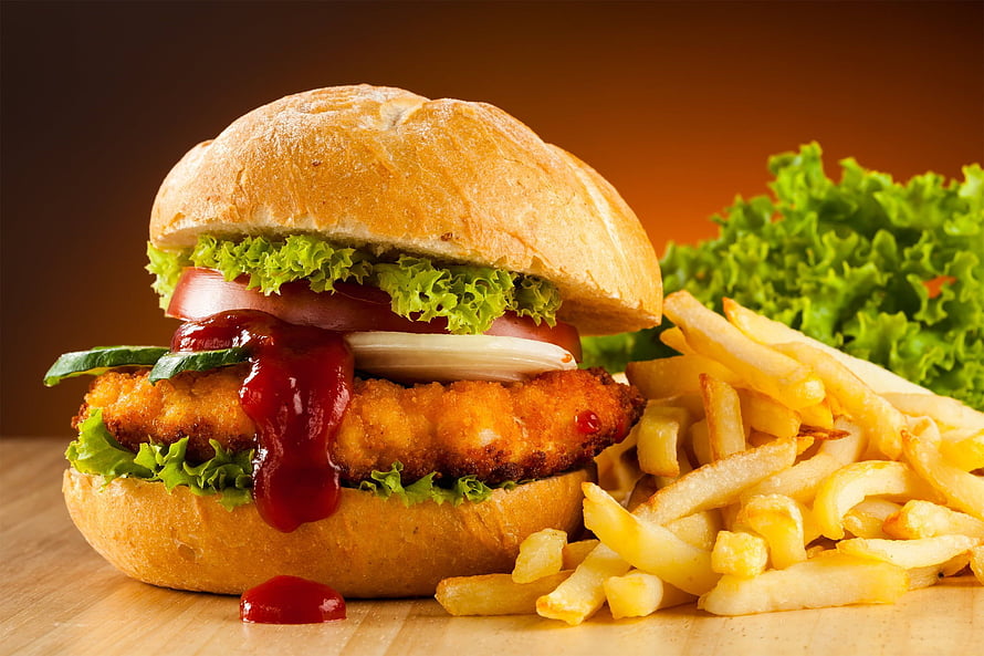 Delicious Fried Chicken Burger with Crispy Fries and Fresh Lettuce on Wooden Table HD wallpaper
