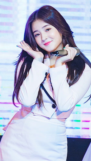 Nancy from Momoland performing on stage in a white suit holding a microphone HD phone wallpaper