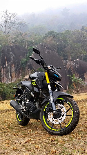 Black Yamaha MT-15 Motorcycle with Neon Green Accents in Misty Mountain Landscape HD phone wallpaper