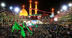 Night view of Imam Reza shrine in Mashhad with massive crowd waving green flags during religious procession HD wallpaper