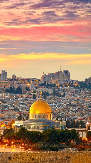 Dome of the Rock in Jerusalem at Sunset with Golden Sky and Cityscape HD phone wallpaper