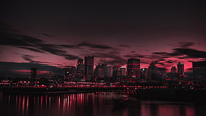 Dramatic Red and Black City Skyline at Night with Water Reflections HD wallpaper