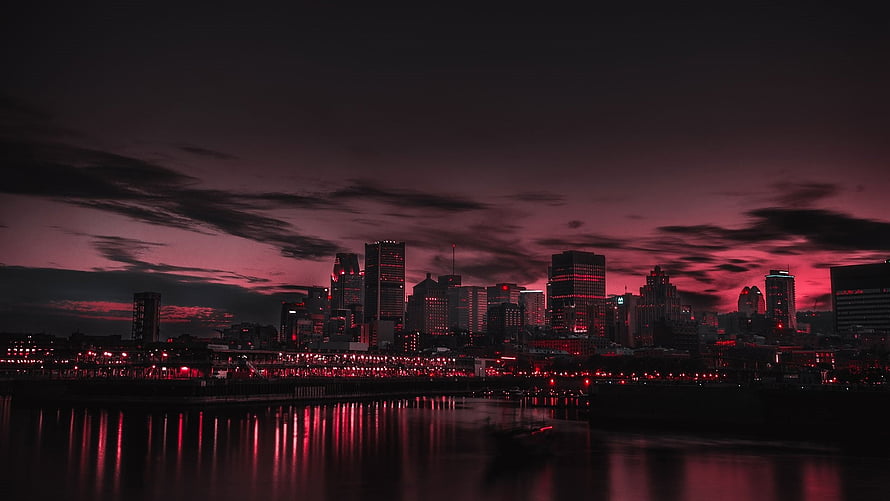 Dramatic Red and Black City Skyline at Night with Water Reflections HD wallpaper
