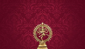 Golden Nataraja statue performing the cosmic dance on a deep red damask patterned background HD wallpaper