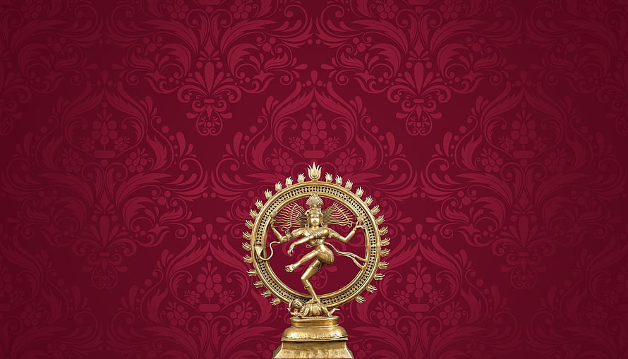 Golden Nataraja statue performing the cosmic dance on a deep red damask patterned background HD wallpaper