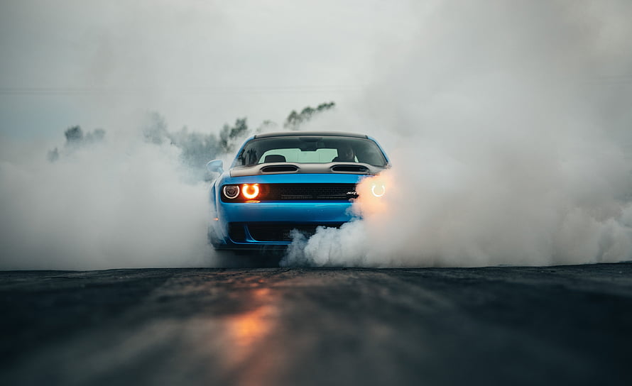 Blue Dodge Challenger Hellcat Performing a Smoky Burnout on Asphalt HD wallpaper