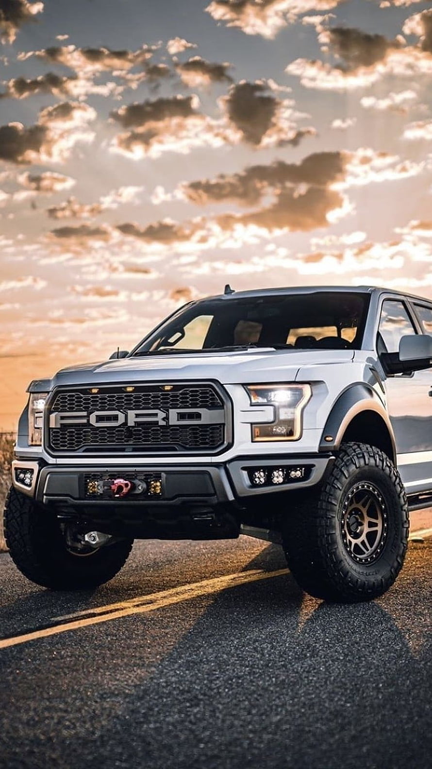 Silver Ford Raptor Super Duty Pickup Truck with Off-Road Tires on a Desert Road at Sunset HD phone wallpaper