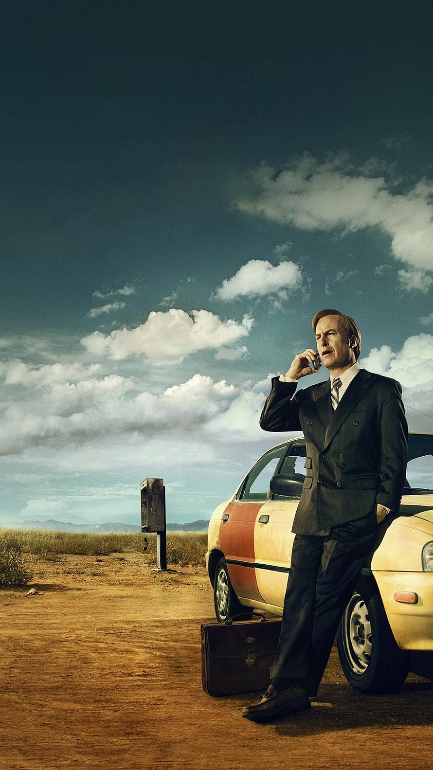 Saul Goodman in a dark suit leaning against a car in a desert landscape while talking on a phone, Saul Goodman , Saul Breaking Bad HD phone wallpaper
