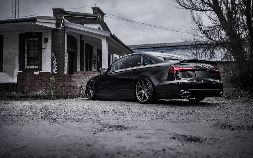 Black Audi A6 C7 Sedan Rear Three-Quarter View Parked on Gravel HD wallpaper