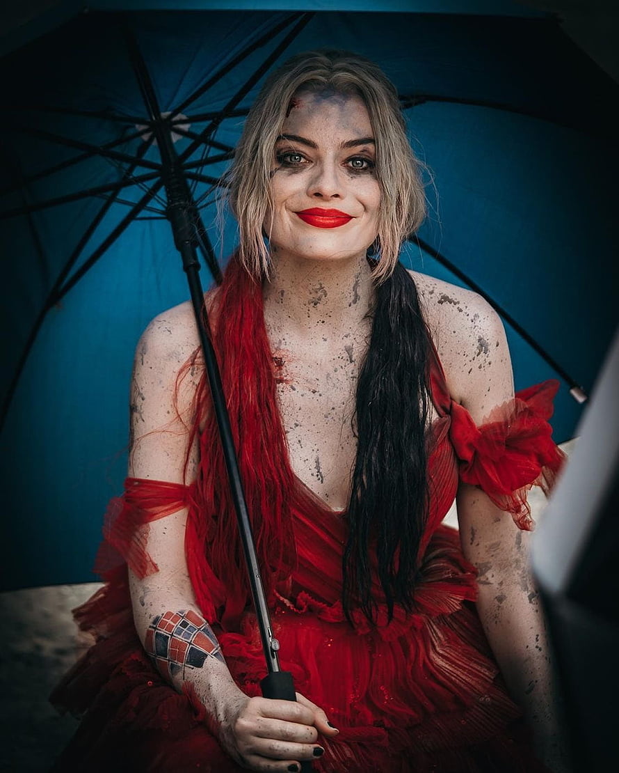 Harley Quinn in Red Dress Holding Blue Umbrella with Mud Splatters and Joker Tattoo HD phone wallpaper