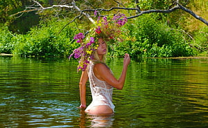 Blonde Woman in White Dress Wearing a Vibrant Flower Crown in a Serene Green Lake, Bathing Beauty, graphy, blonde, art, girl, beautiful, serene, flowercrown, bathing, woman, nature, flowers, water HD wallpaper