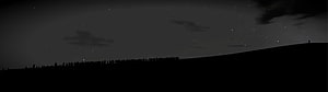 Silhouetted Crowd on a Hill Under a Starry Night Sky HD wallpaper