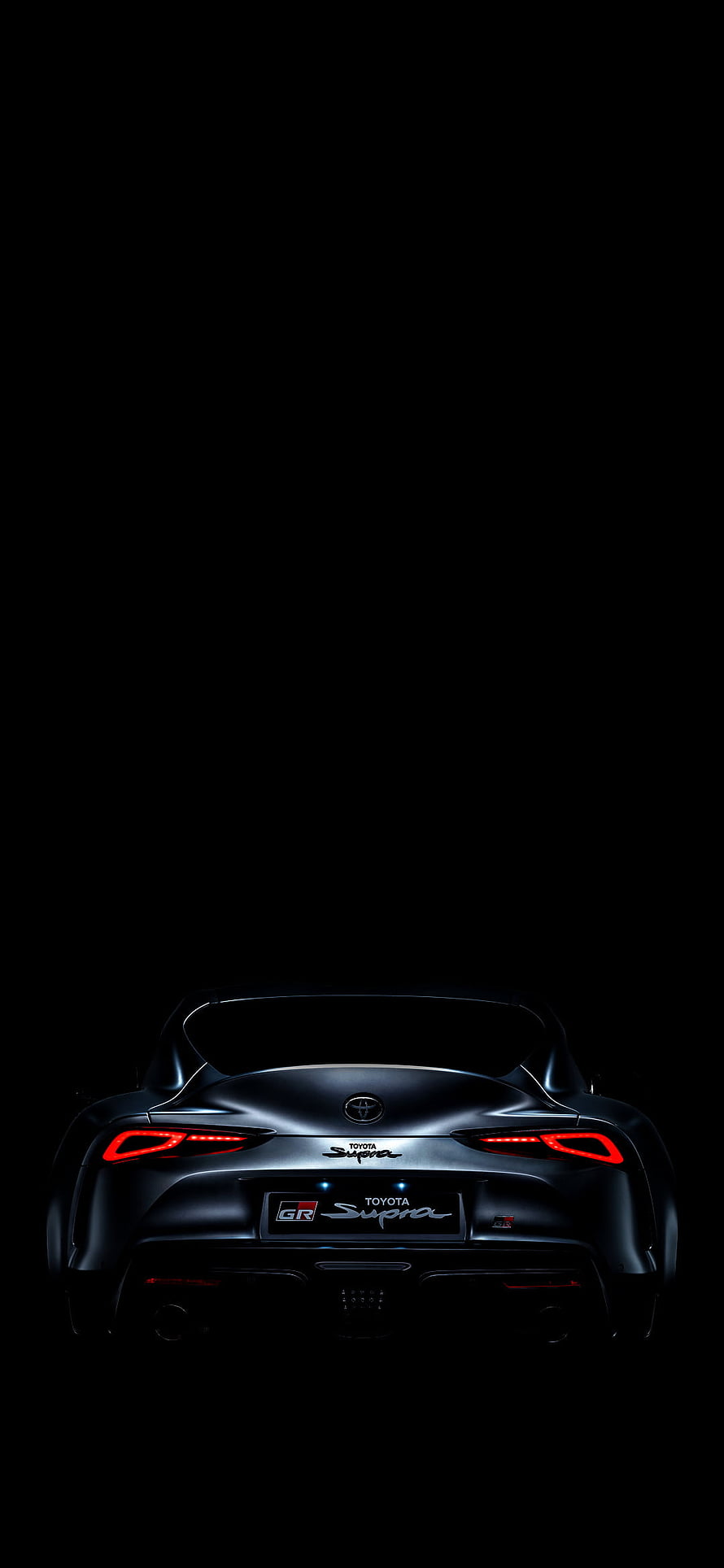 Rear View of Black Toyota GR Supra A90 with Glowing Red Taillights Against Dark Background HD phone wallpaper