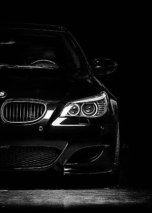 Black and White Close-Up of a BMW E60 M5 Front Grille and Headlights in Dramatic Low-Light Setting HD phone wallpaper