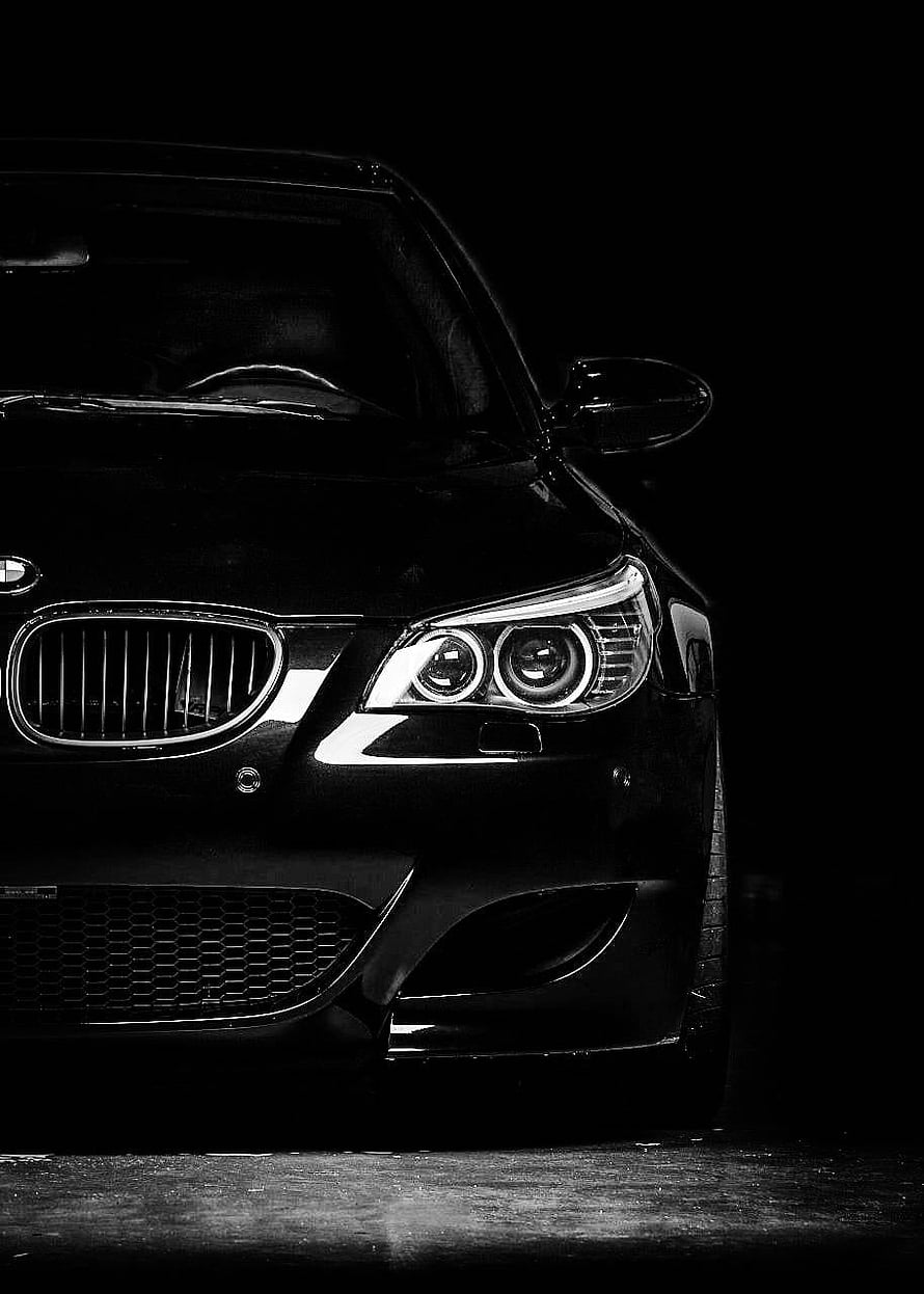Black and White Close-Up of a BMW E60 M5 Front Grille and Headlights in Dramatic Low-Light Setting HD phone wallpaper