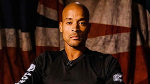 David Goggins Portrait In Black Shirt Against American Flag Background HD wallpaper