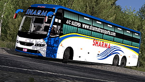 Volvo B11R Sleeper Bus in Blue and White Livery Driving on a Forest Road HD wallpaper