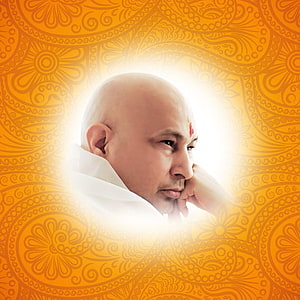 Portrait of a bald man with a tilak on his forehead, wearing white robes and resting his chin on his hand, set against a glowing orange mandala background, GuruJi - World of Blessings HD phone wallpaper