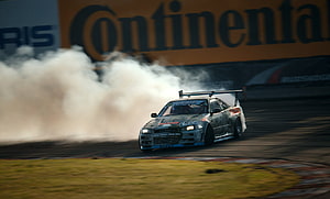 Subaru Impreza WRX STI drifting on a racetrack with smoke HD wallpaper