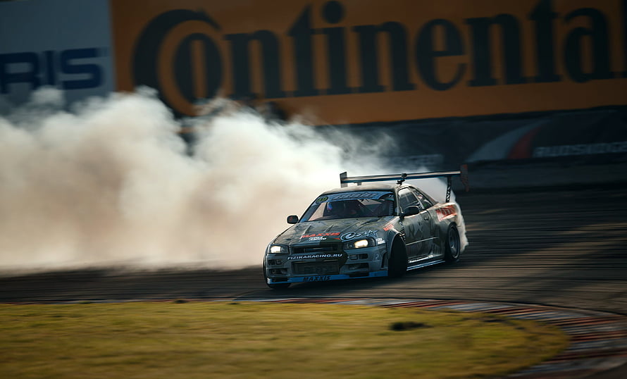 Subaru Impreza WRX STI drifting on a racetrack with smoke HD wallpaper