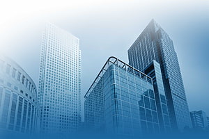 Modern Corporate Glass Skyscrapers Against a Bright Blue Sky HD wallpaper