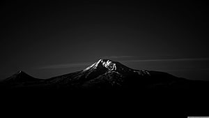 Dramatic Black and White Mountain Peak Silhouette with Snow-Capped Summit HD wallpaper