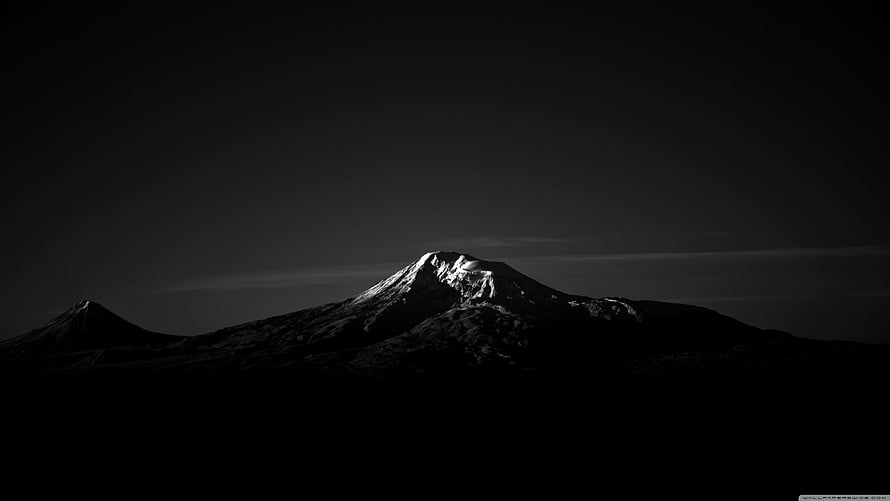 Dramatic Black and White Mountain Peak Silhouette with Snow-Capped Summit HD wallpaper