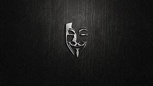 Metallic Guy Fawkes Mask on Dark Textured Background HD wallpaper