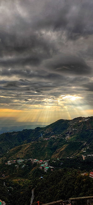 Mussoorie India Mountain View with Dramatic Sunbeams Breaking Through Storm Clouds Over Lush Green Hills HD phone wallpaper