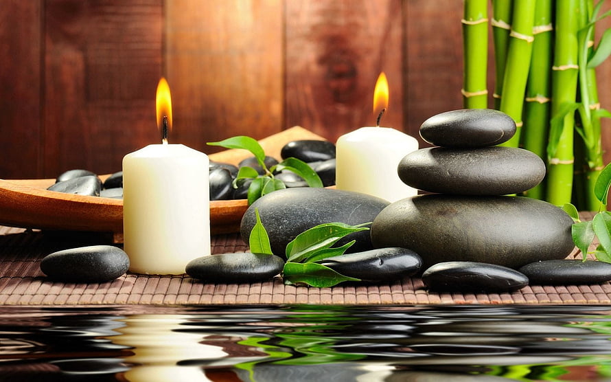 Serene Spa Still Life With Stacked Black Stones, Lit Candles, Bamboo, and Water Reflection HD wallpaper