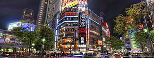 Tokyo Cityscape at Night with Vibrant Neon Signs and Busy Streets HD wallpaper