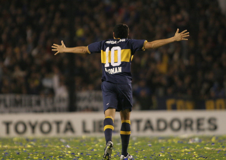 Juan Roman Riquelme celebrating in Boca Juniors blue and yellow jersey with arms outstretched on the pitch, Juan Roman Riquelme. Club atlético boca juniors, Boca juniors HD wallpaper