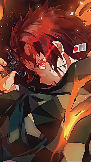 Tanjiro Kamado from Demon Slayer in Intense Combat with Glowing Red Eyes and Fire Effects HD phone wallpaper