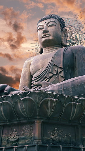 Meditating Buddha Statue Seated on Lotus Pedestal at Sunset HD phone wallpaper