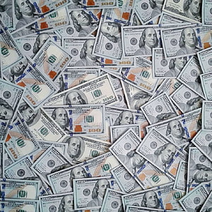 Scattered pile of one hundred dollar bills with Benjamin Franklin portraits HD phone wallpaper