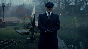 Tommy Shelby in Peaky Blinders Standing in a Misty Industrial Yard HD wallpaper